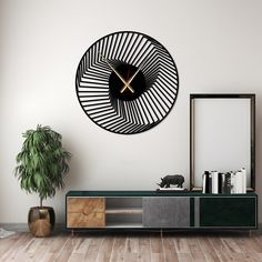 a clock on the wall above a sideboard with a plant in front of it