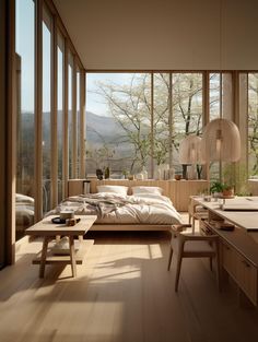 a bedroom with wooden floors and large windows overlooking the trees in the distance is shown