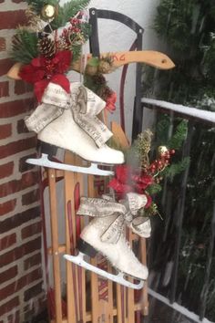 a sled with christmas decorations and snow shoes on it's front porch in the winter