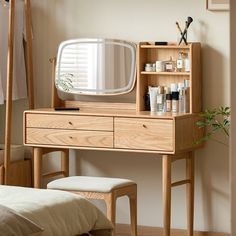 a wooden dressing table with a mirror and stool in the corner next to a bed