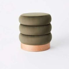 three round stools stacked on top of each other in front of a white background