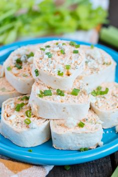 several pieces of tofu on a blue plate with celery in the background