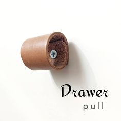 a roll of toilet paper sitting on top of a white wall with the word drawer pull written below it