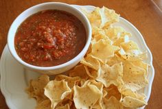 a white plate topped with chips and salsa