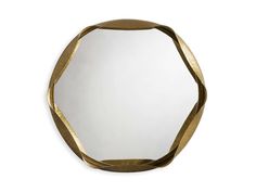 a mirror that is sitting on top of a white wall with a gold ribbon around it