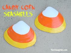 candy corn seashells are painted orange, white and yellow with the words candy corn seashells above them