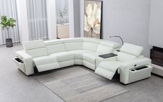 a modern living room with white leather furniture