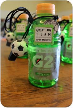 there is a green bottle with a soccer ball on it