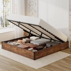 a bed that is sitting in the middle of a room with a mattress on top of it