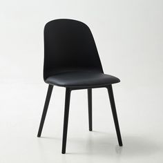 a black chair sitting on top of a white floor