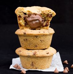 three muffins stacked on top of each other with chocolate in the middle and scattered around them