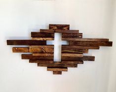 a cross made out of wooden planks on a wall