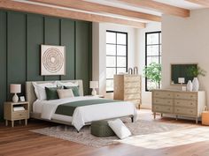 a bedroom with green walls and white bedding in the center, wooden flooring