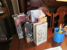 a wooden table topped with lots of paper bags