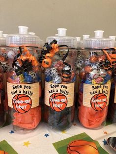 basketball themed party favors in plastic bottles on a table with napkins and place mats