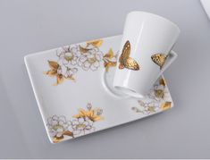 two coffee cups and saucer with butterflies on them