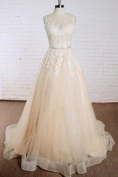 a dress on a mannequin in front of a white brick wall and floor