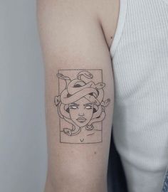 a woman's arm with a black and white portrait tattoo on the left upper arm