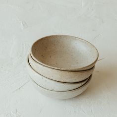 three white bowls stacked on top of each other