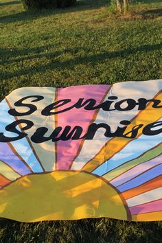 a sign that says sedon sunrise on it in front of some grass and trees