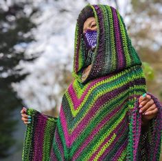 a woman wearing a colorful crocheted shawl