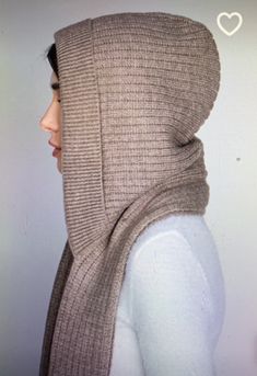 a woman wearing a scarf with the hood up