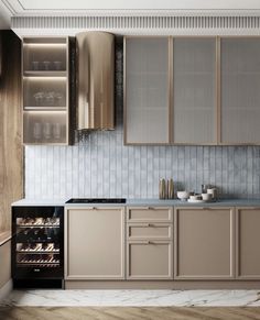 a modern kitchen with an oven, refrigerator and cabinets in light brown tones is shown