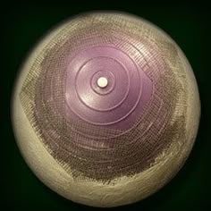 a purple and white vase sitting on top of a table