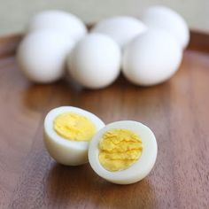 hard boiled eggs sitting on top of a wooden table