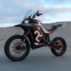 a black and silver motorcycle parked on top of a dirt field