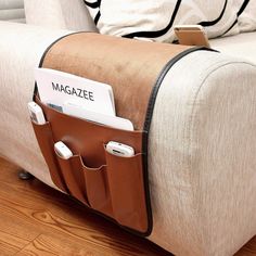 a magazine holder is attached to the back of a couch