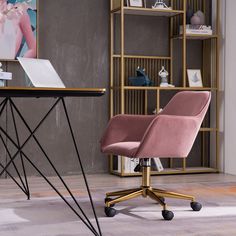 a pink chair sitting in front of a desk with a laptop computer on top of it