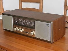 an old radio sitting on top of a wooden table