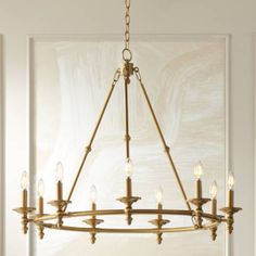 a chandelier hanging from the ceiling in a room with white walls and flooring