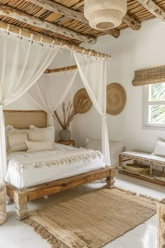 a white bed sitting in a bedroom next to a wooden table and chair on top of a rug