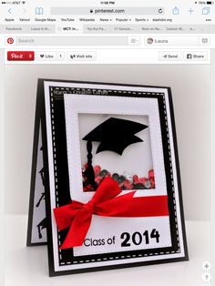 a graduation card with a red ribbon and a graduate's cap in the center