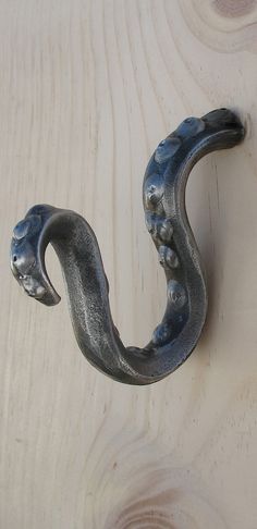 a metal hook on the side of a wooden wall