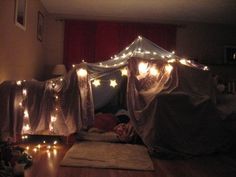 a bedroom with lights on the ceiling and curtains over it's bedspread