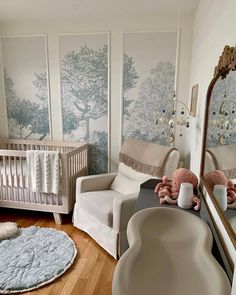 a baby's room with two cribs, a couch and a mirror