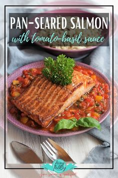 pan - seared salmon with tomato basil sauce on a plate next to a bowl of rice