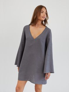 UMA is a short and flowy linen mini dress with a relaxed, slightly oversized fit. It features a deep V-neckline and 70s-inspired wide, flowing bell sleeves. DETAILS - Deep V-neckline - Wide, flowing bell sleeves - A-line silhouette - Mini length - Side seam pockets COLOR - Light Grey (featured color) - Multiple colors available in dropdown menu above - See all color options & order fabric samples here: https://www.etsy.com/listing/586569696/linen-fabric-samples SIZING & FIT - Relaxed fit - The m Dress Bell Sleeves, Linen Tunic Dress, Flare Sleeve Dress, Linen Mini Dress, Linen Tunic, Dress Tunic, 70s Inspired, Large Bust, Linen Dress