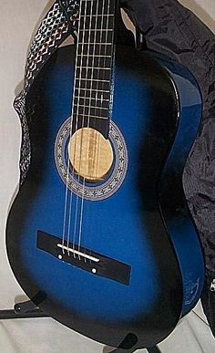 a blue guitar sitting on top of a black case