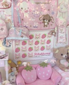 there are many stuffed animals and toys in this room, including strawberry shaped bedspreads