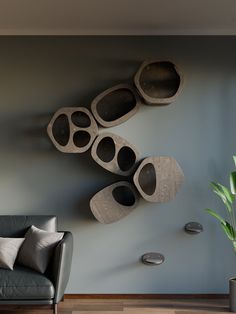 a living room with a couch and some decorative objects on the wall next to a potted plant