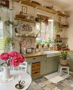 the kitchen is decorated with pink flowers and greenery