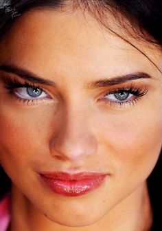 a close up of a woman with blue eyes