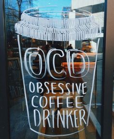 a coffee shop window with the words ocid obsesive coffee drinker written on it