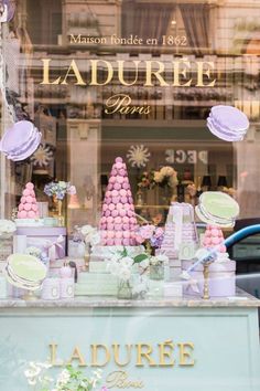 a store front window filled with lots of cakes and candies