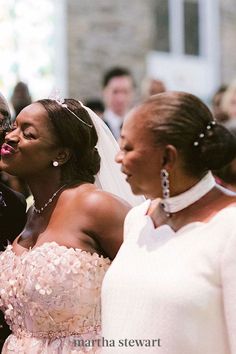 the bride and groom are standing next to each other in front of an audience at a wedding