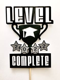 a cake topper that says level one complete with stars and a trophy on it